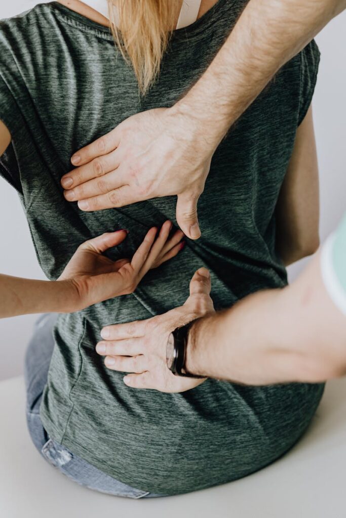 A chiropractor examining a patient's back to alleviate pain and discomfort.